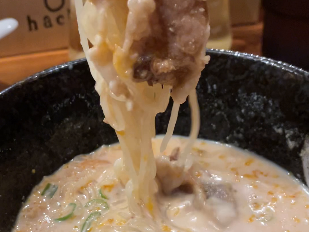 hachi取材時、白いスープから麺と肉を持ち上げる場面